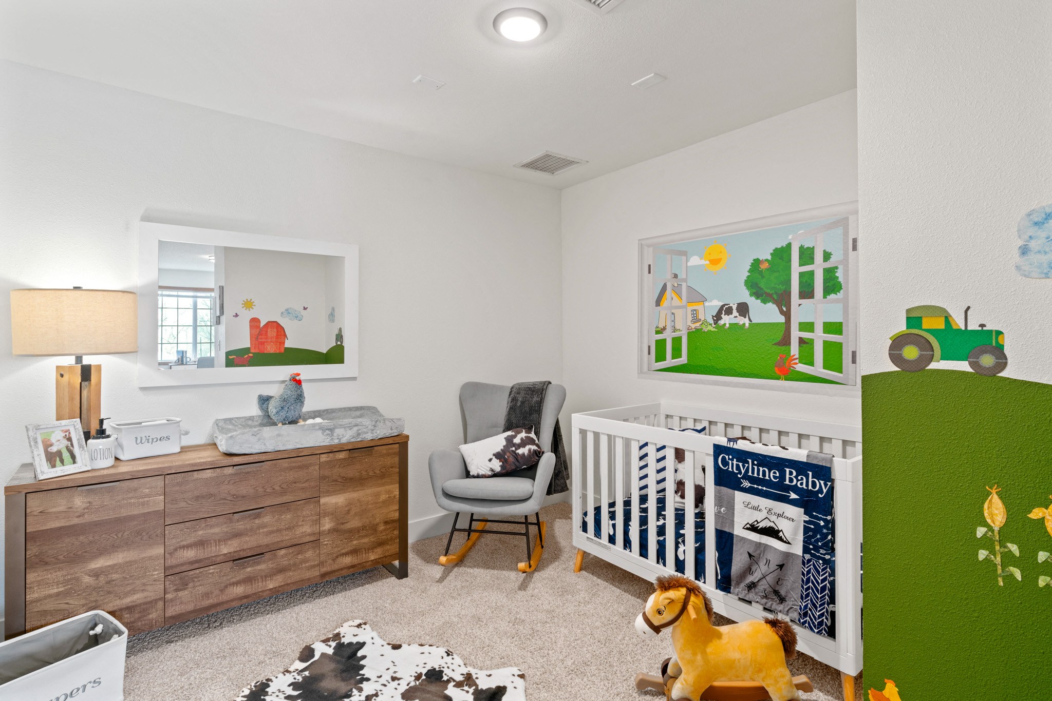 a nursery with a white crib and a dresser with a wooden dresser and a chair